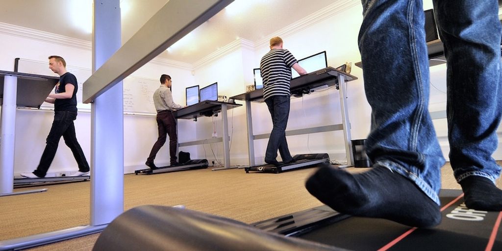 software testing concept illustration, diverse team of developers testing software on computers in a modern office