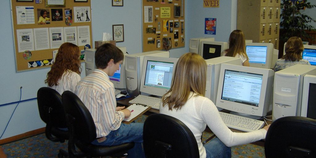 team of software testers working on computers in a modern office